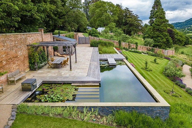 L shaped lily pond spring garden inspiration for hedgerows